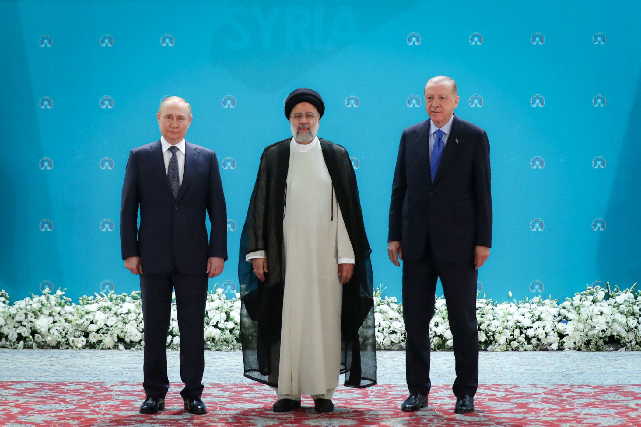 Posing for a photo in Teheran before a meeting of leaders from the three guarantor states of the...