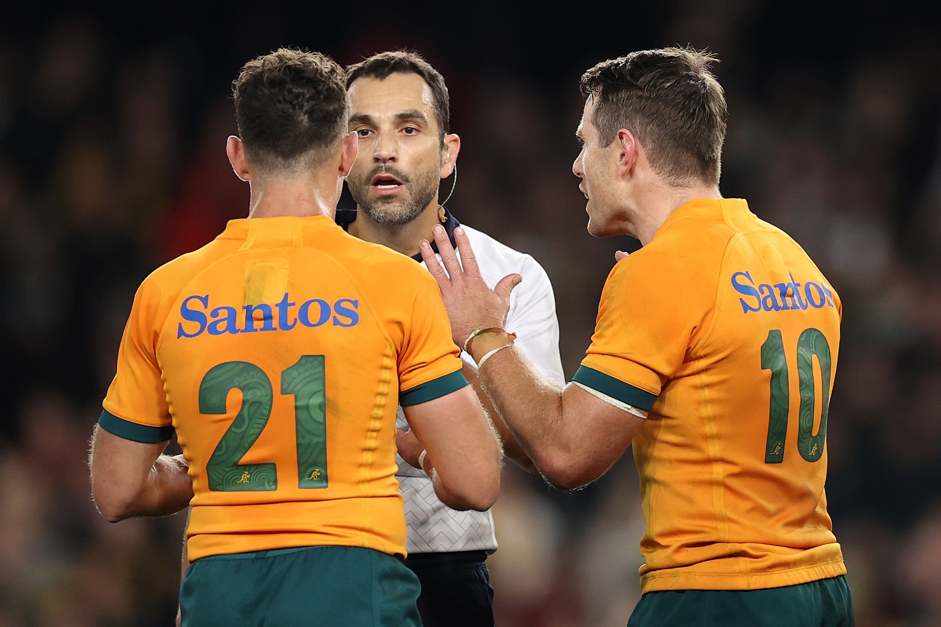 Referee Mathieu Raynal speaks to Nic White and Bernard Foley after penalising the Wallabies for...