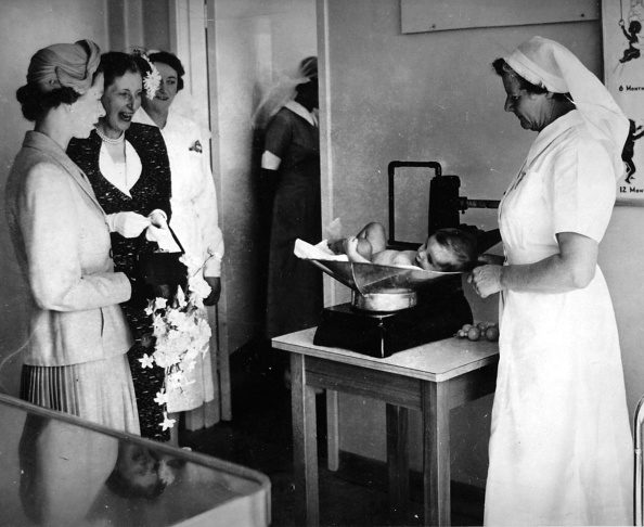 The Queen watches as a baby is weighed at the Karitane Hospital, Anderson's Bay, Dunedin. Photo:...