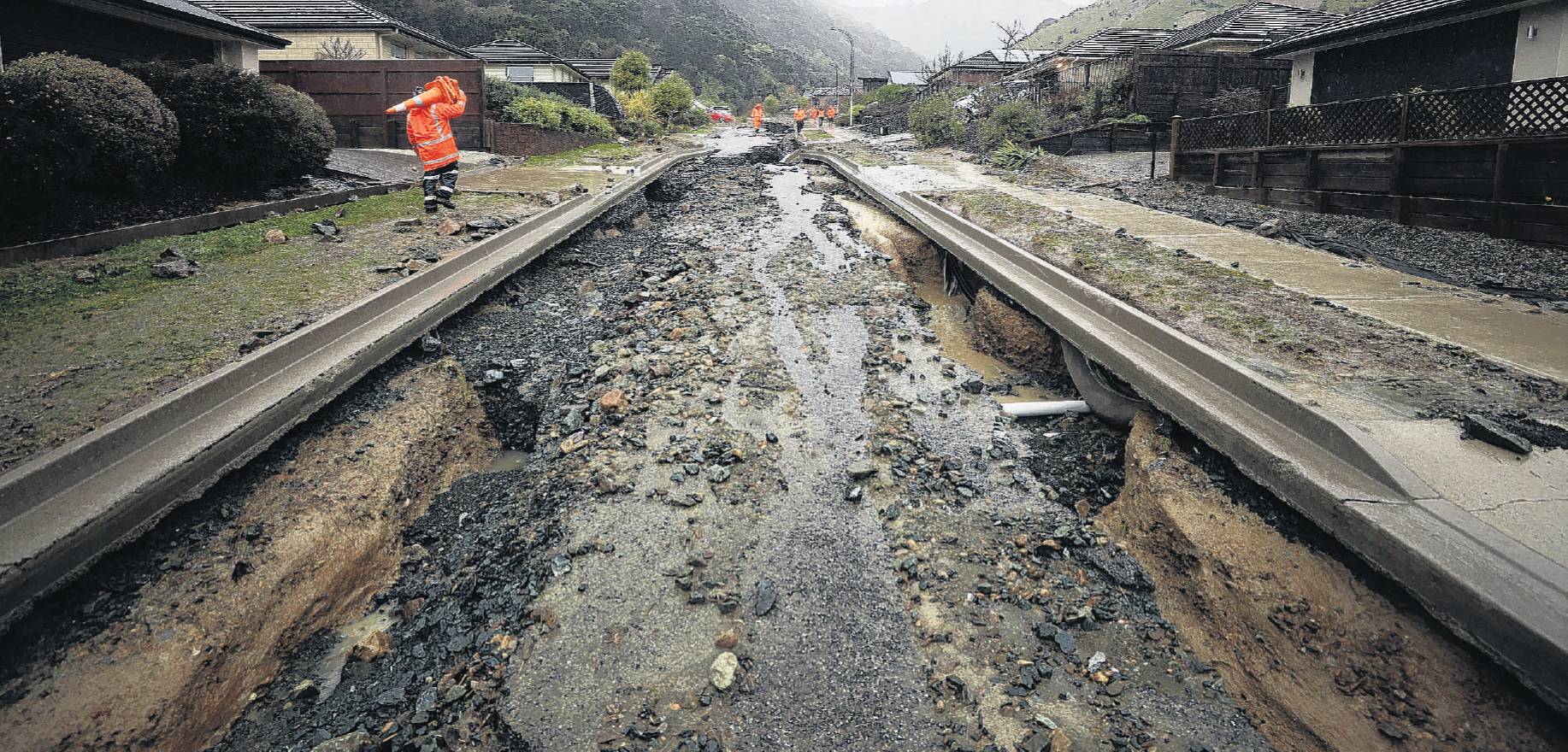 A ruined street and exposed pipes following flooding in Nelson. The extra stresses of climate...