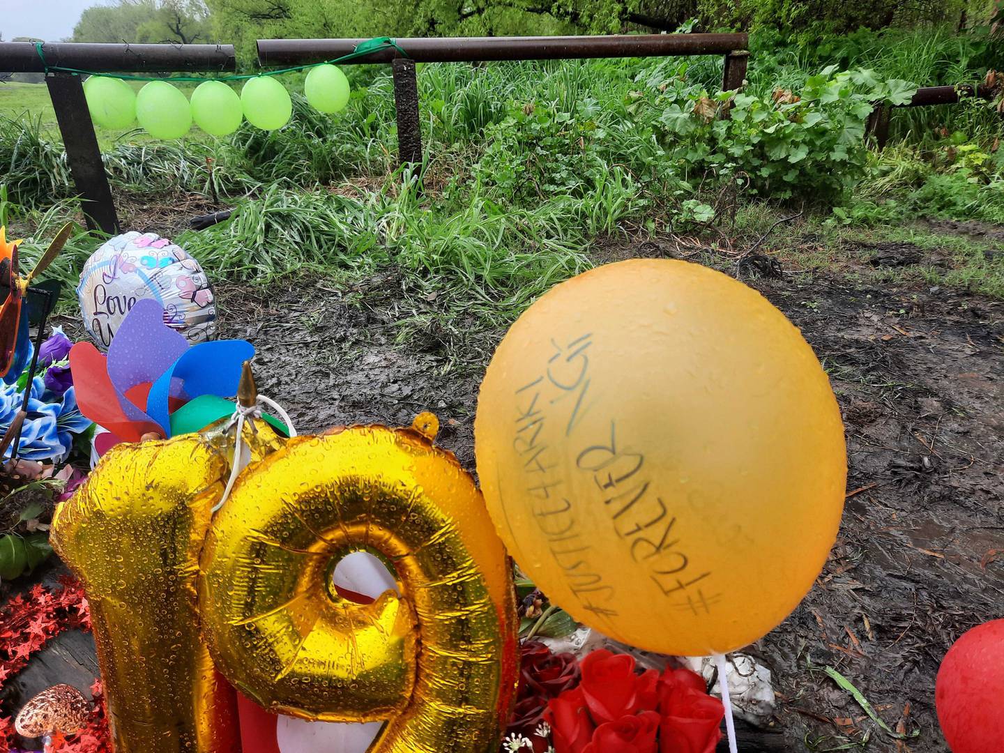 Flowers, cards, balloons and other tributes placed by loved ones of Ariki Rigby at the spot a car...