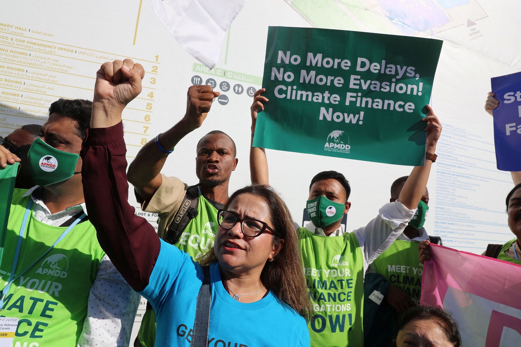 Activists hold banners as they demonstrate at the Sharm El Sheikh International Convention Centre...