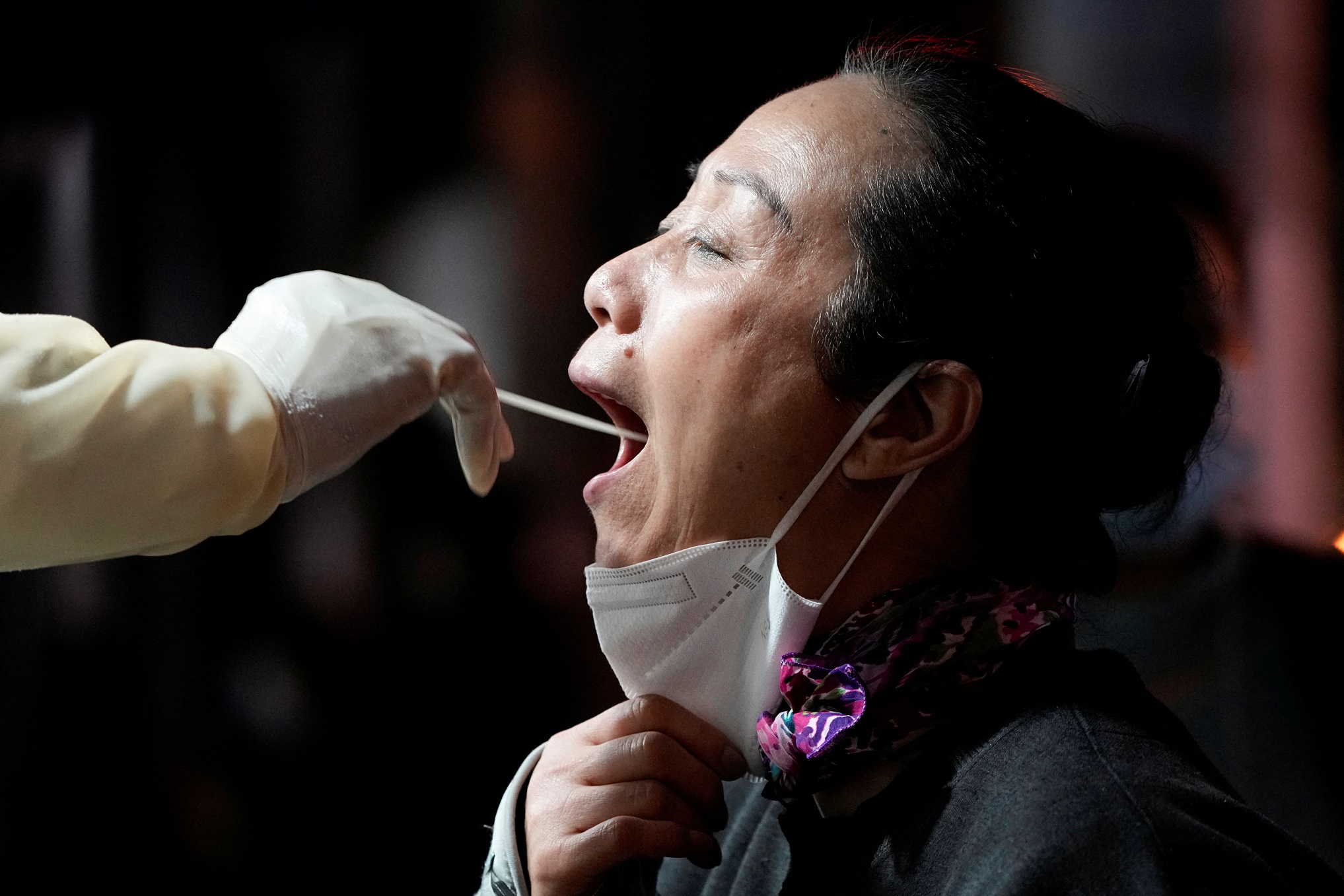 A woman gets tested at a nucleic acid testing site following the Covid-19 outbreak in Shanghai....