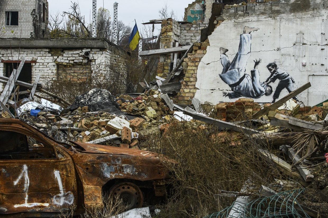 A new graffiti in Banksy's style on the wall of a destroyed residental building in Borodyanka,...