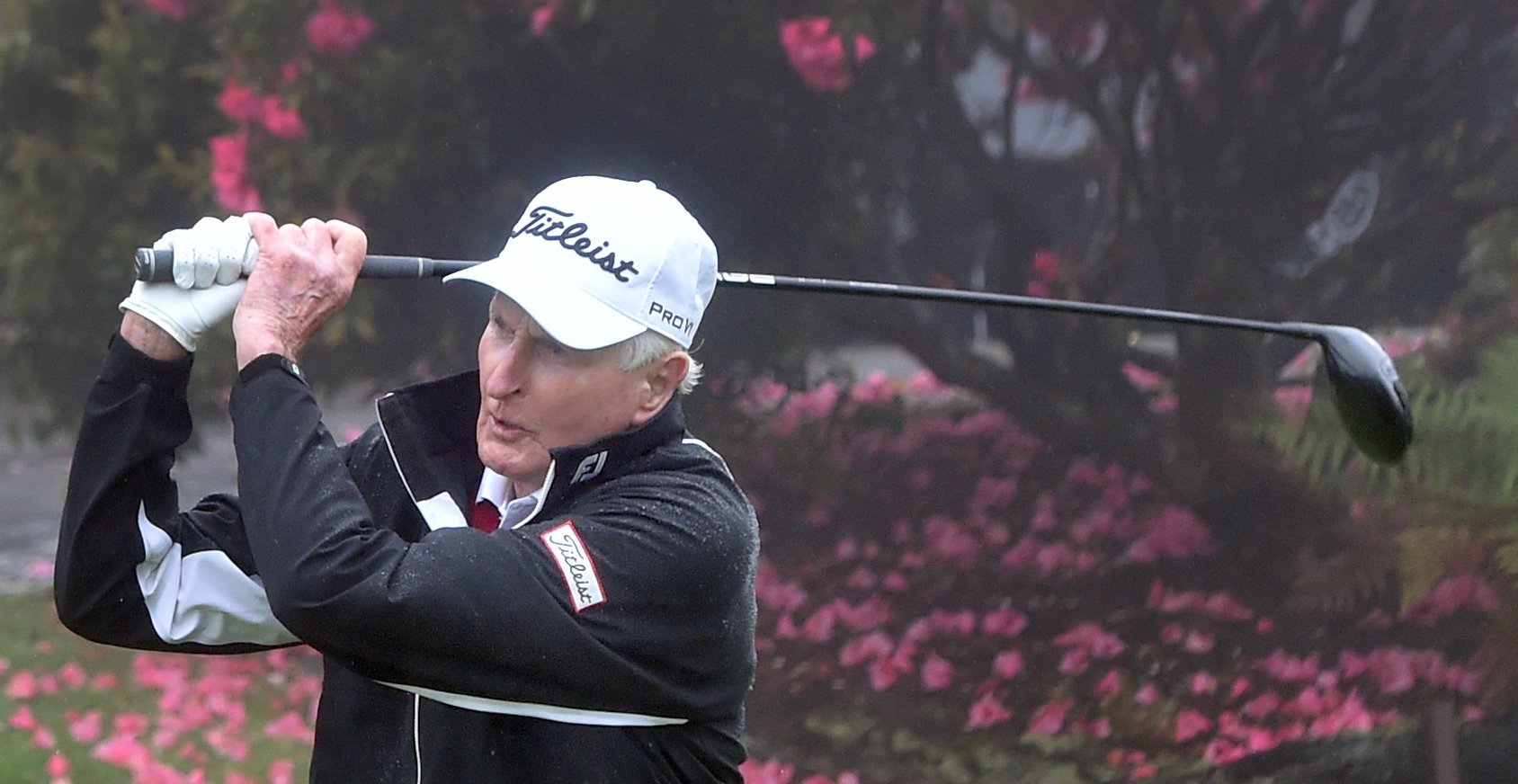 New Zealand golfing great Sir Bob Charles takes a swing on the No 1 tee at the Otago Golf Club in...