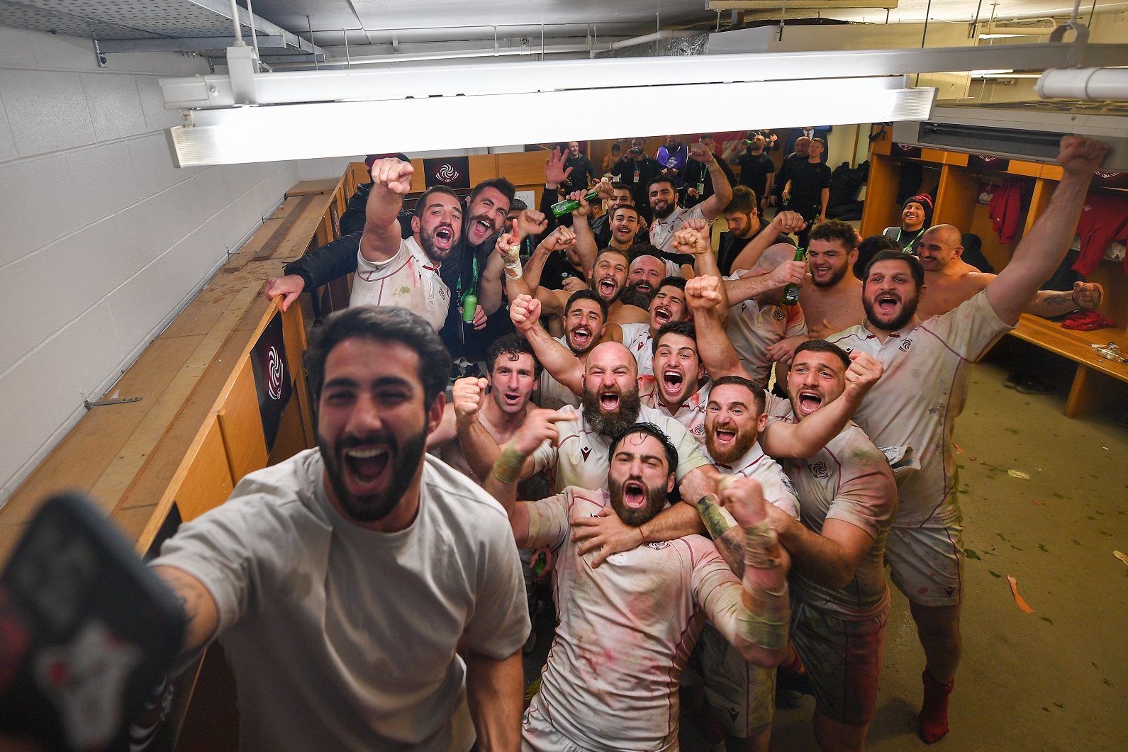Georgian midfielder Giorgi Kveseladze takes a selfie in the dressing room with his team-mates...