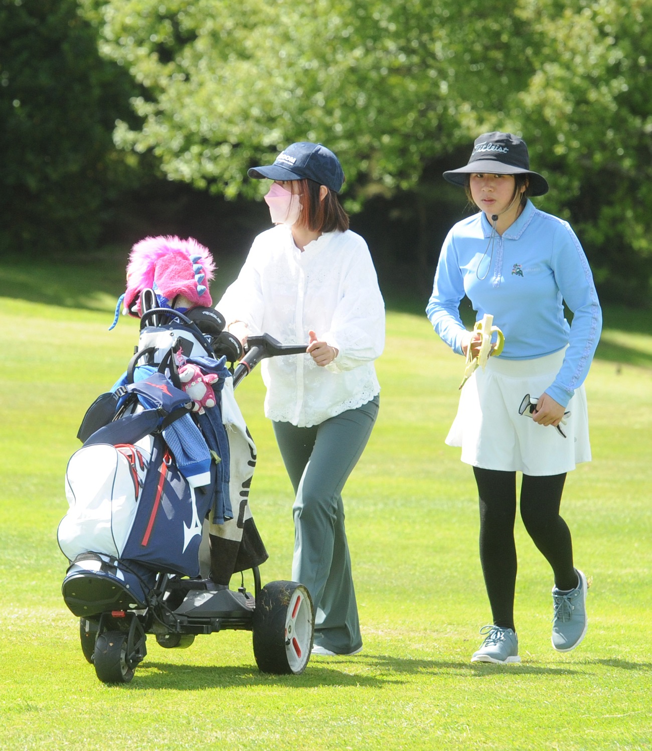 Angeline Loh (Titirangi) snacks on a banana nearing the halfway point of her round while caddy...