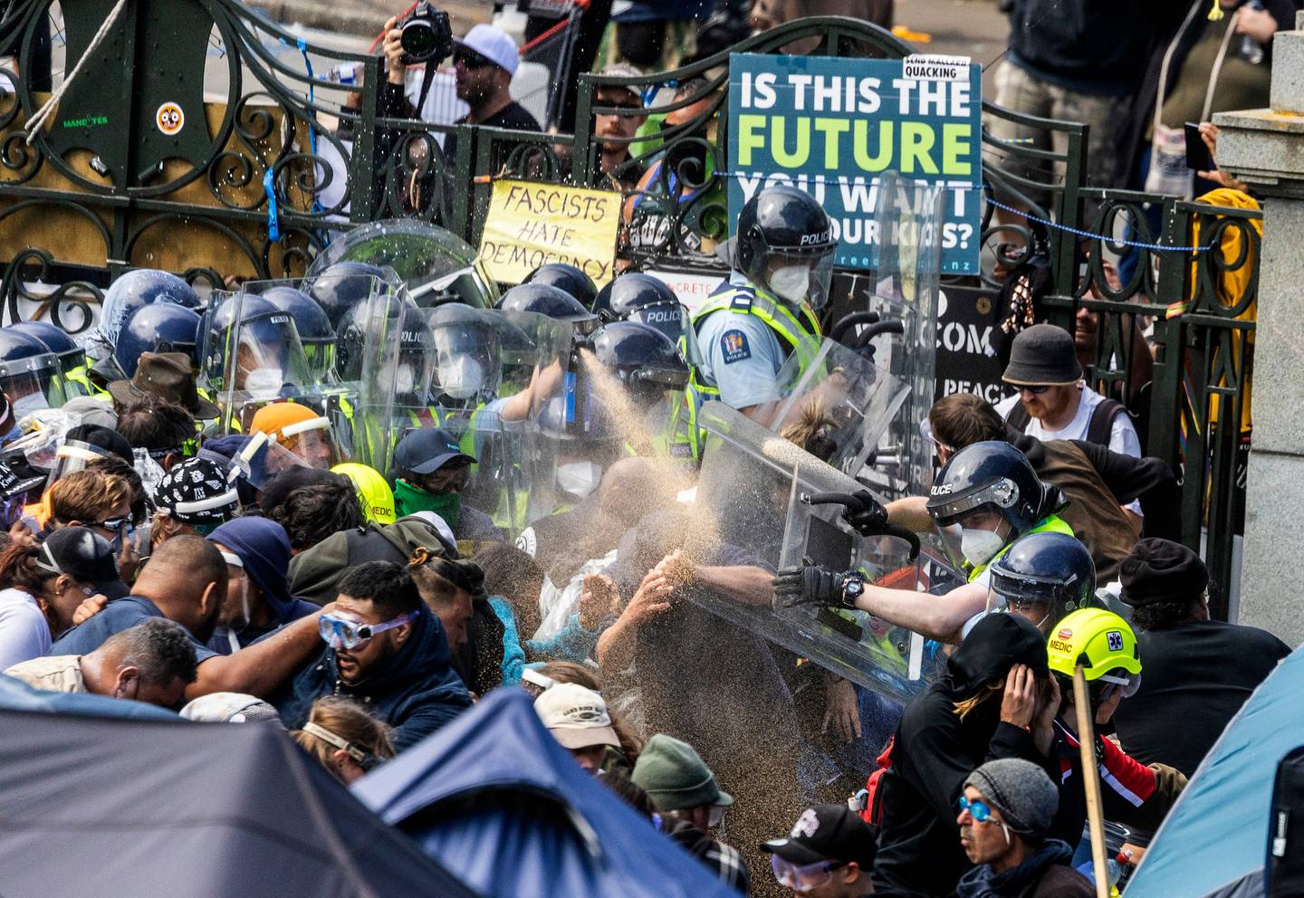 Police clash with protesters while clearing Parliament grounds. Photo: Mike Scott