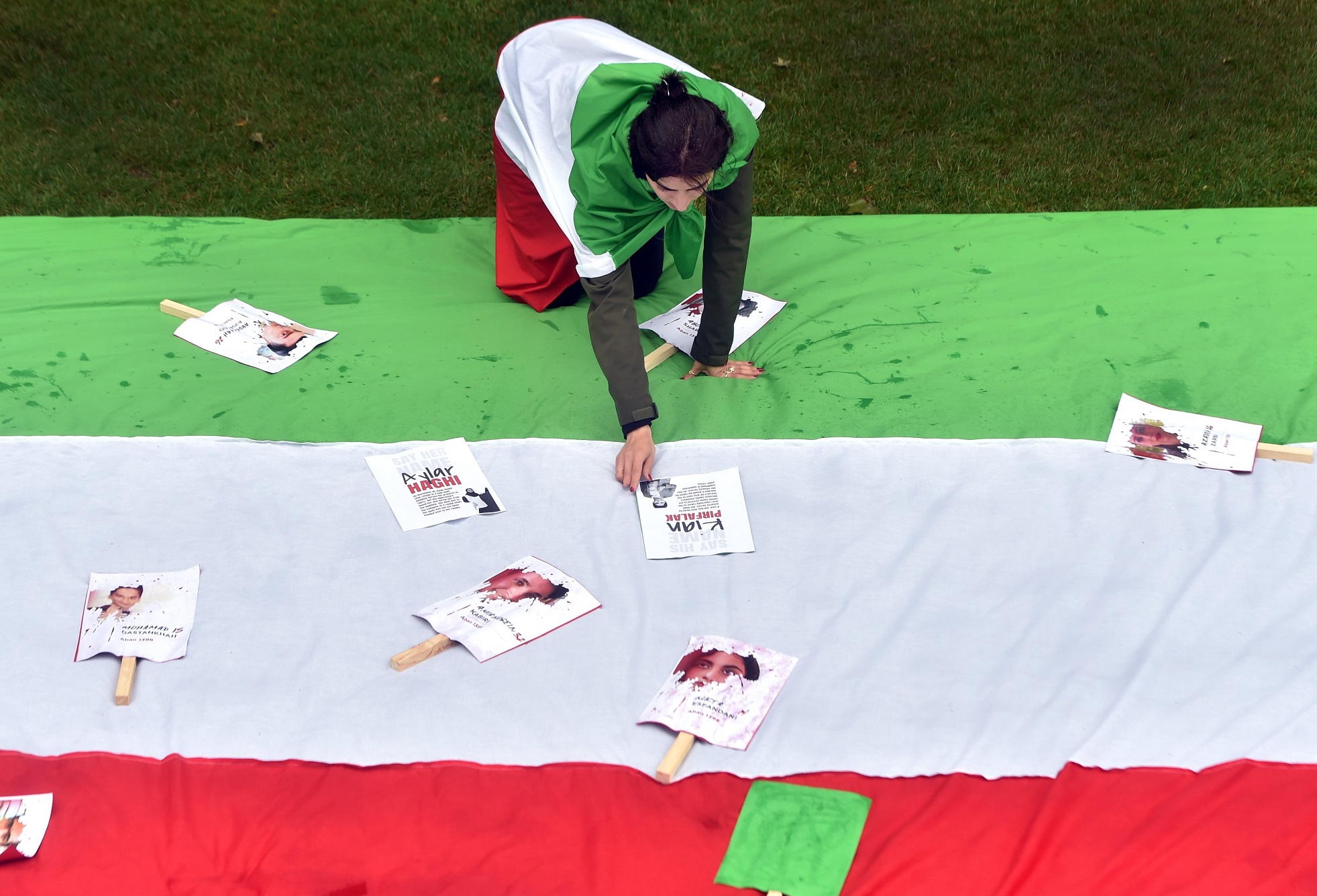 Demonstrator Mitra Mohammadi lays out messages of solidarity in the Octagon at a protest in...