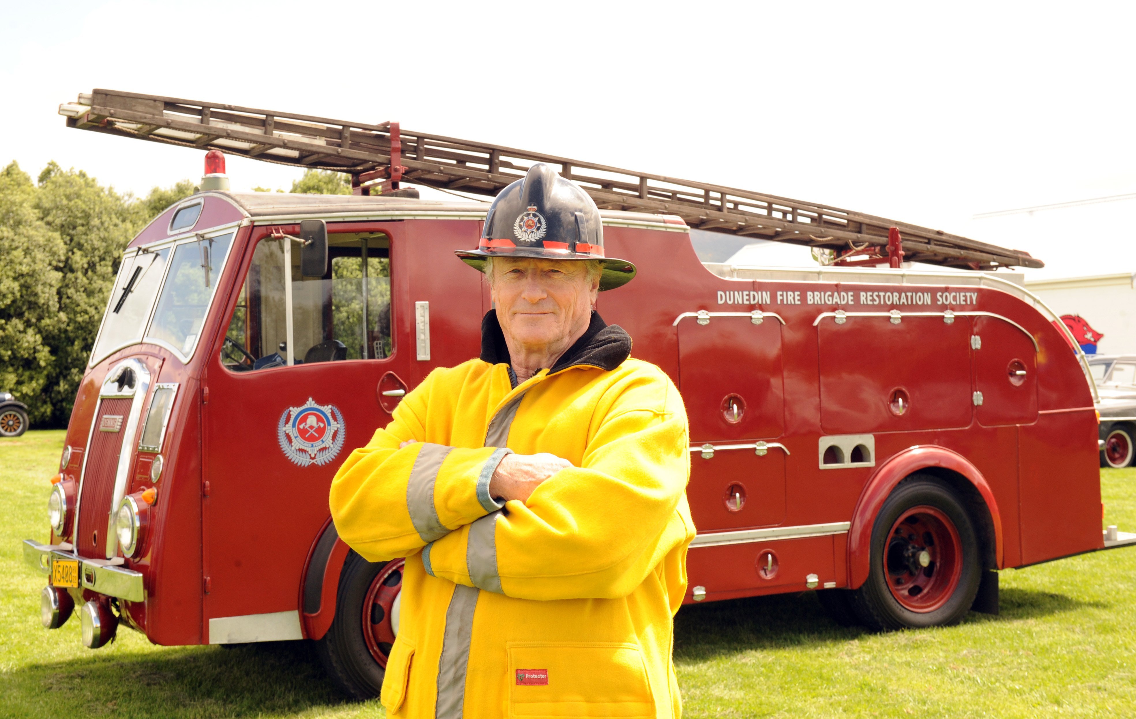 Ex -fireman Errol Thompson stands beside a 1956 Dennis F8 Rolls Royce fire engine owned by the...