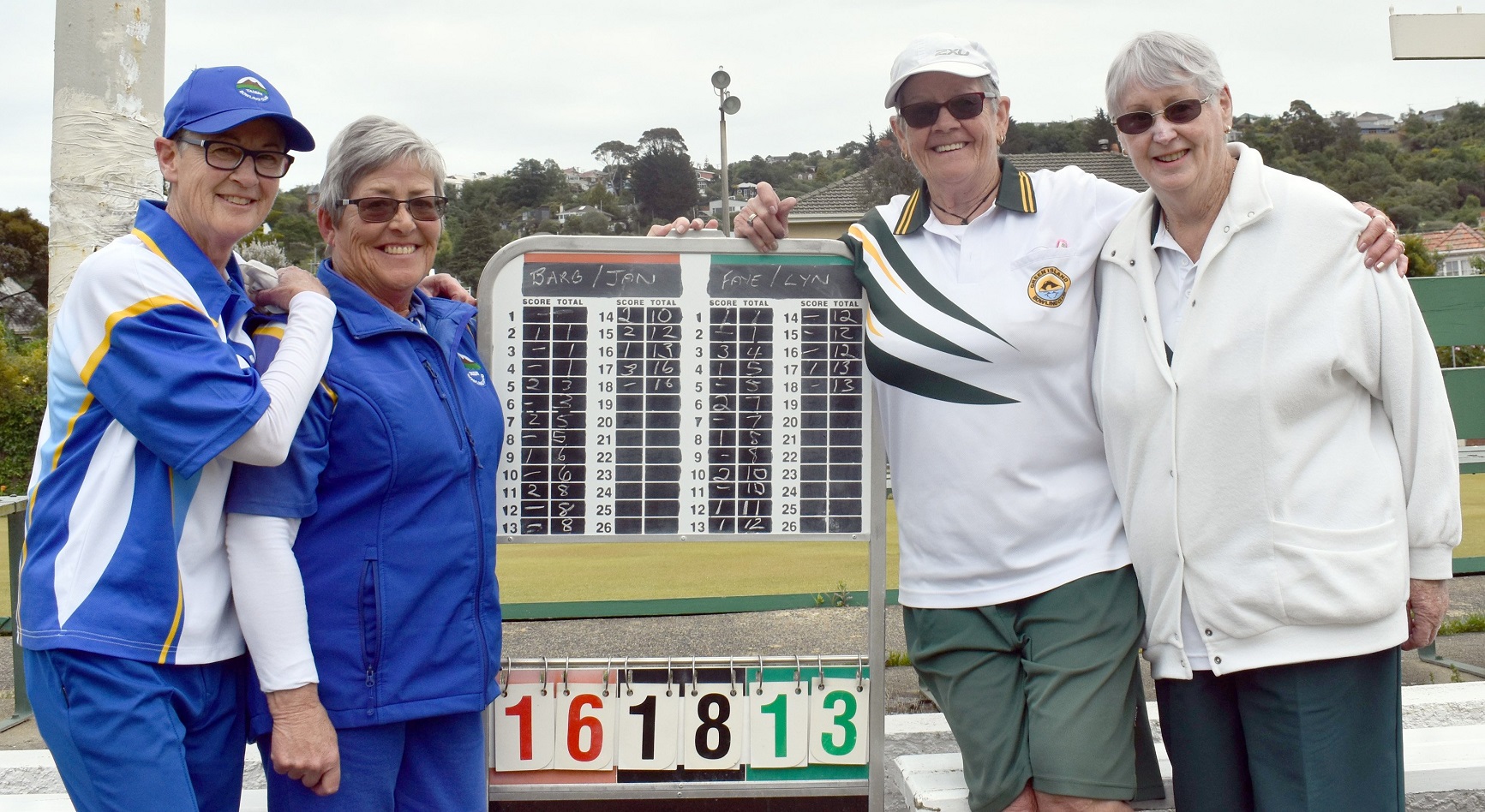 Victorious Taieri pair Jan Hall (left) and Barbara Archer are joined at the scoreboard after...