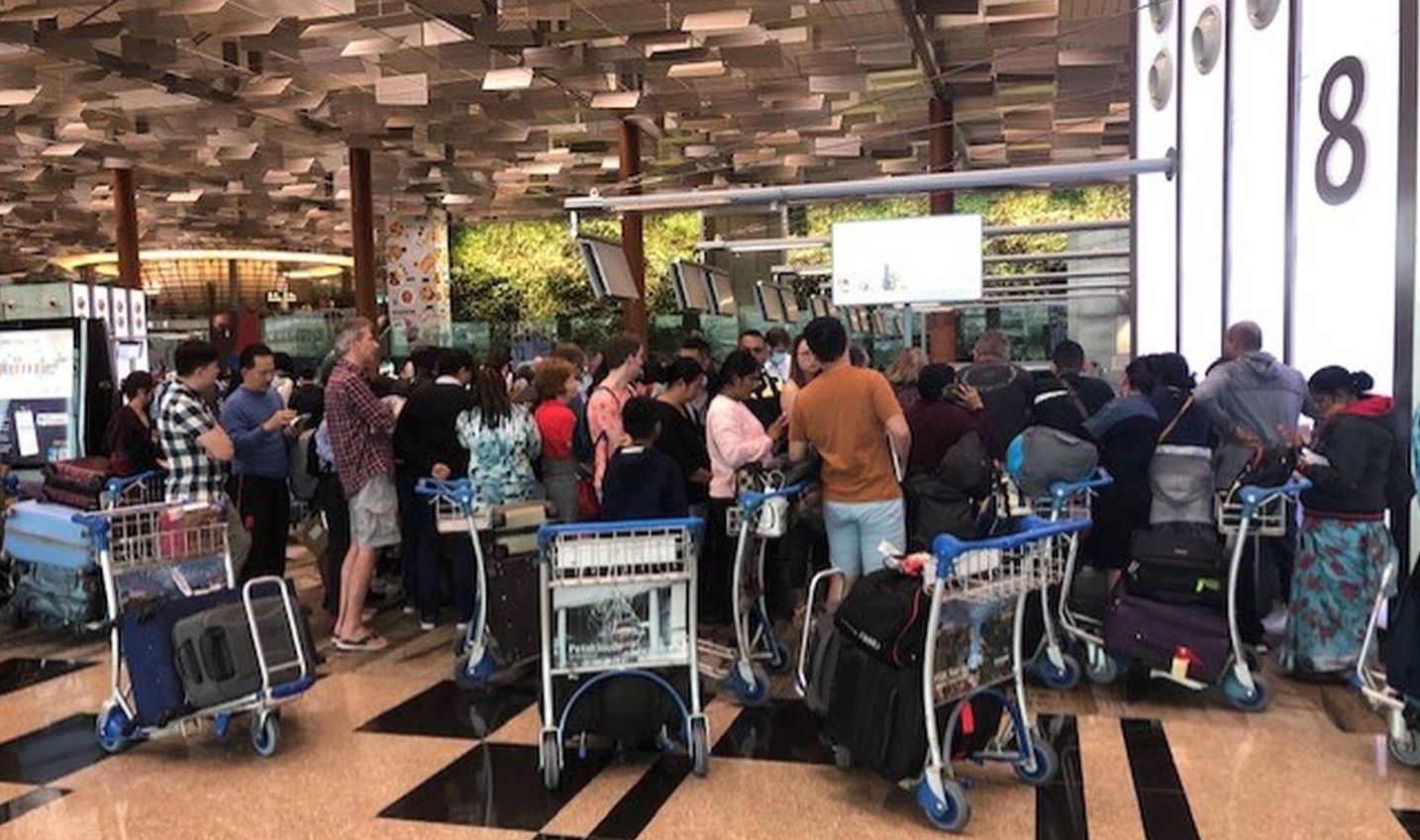 Passengers of flight NZ283 queueing at Singapore Airport following Auckland flood disruption....