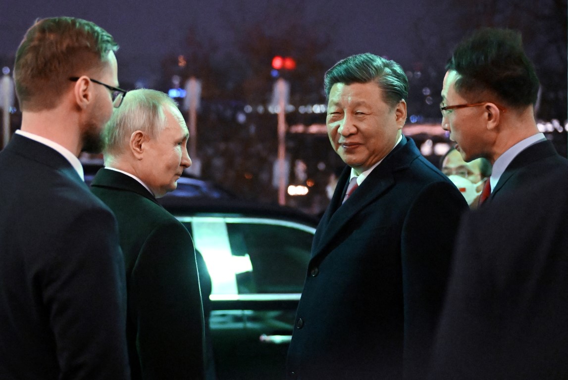 Russian President Vladimir Putin and Chinese President Xi Jinping leave after a reception at the...
