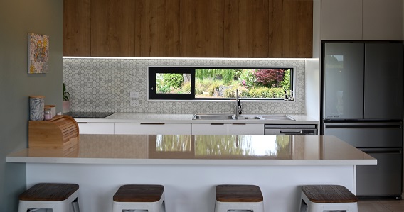 The pared-back kitchen has a home for everything, and includes a door to the garden. PHOTO: CRAIG...