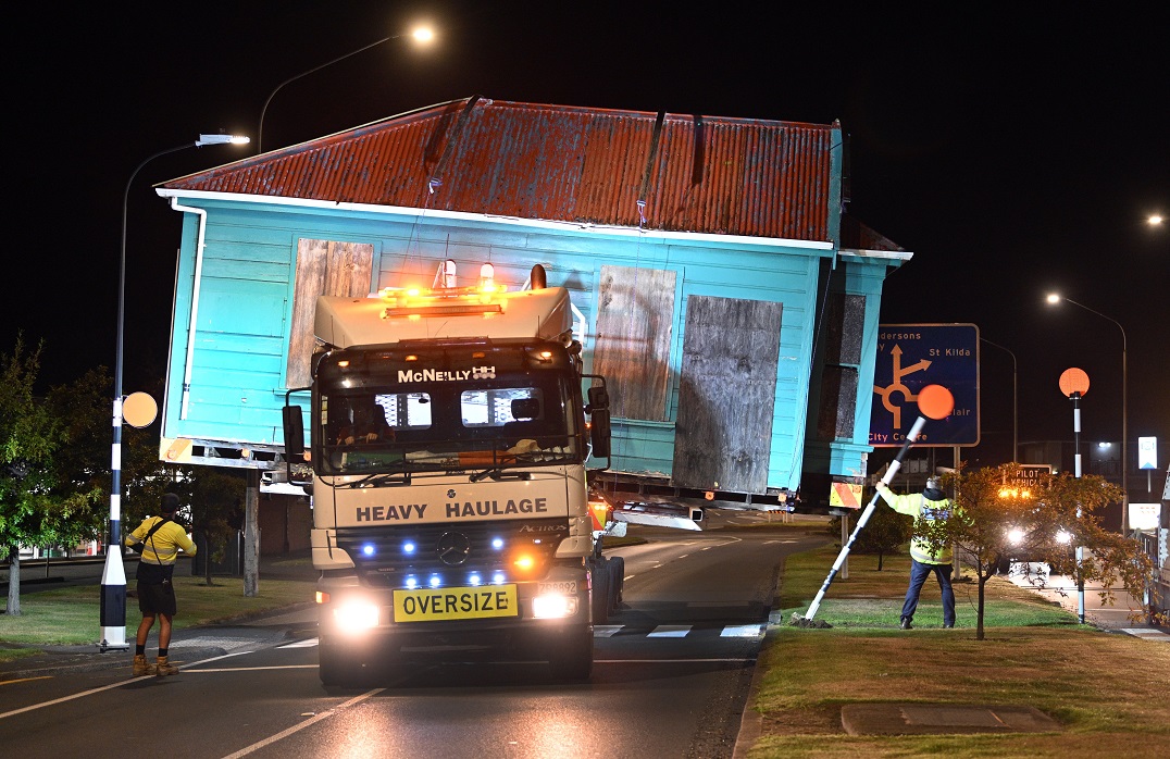 The historic Braemar Cottage makes its way down Andersons Bay Rd early yesterday morning.