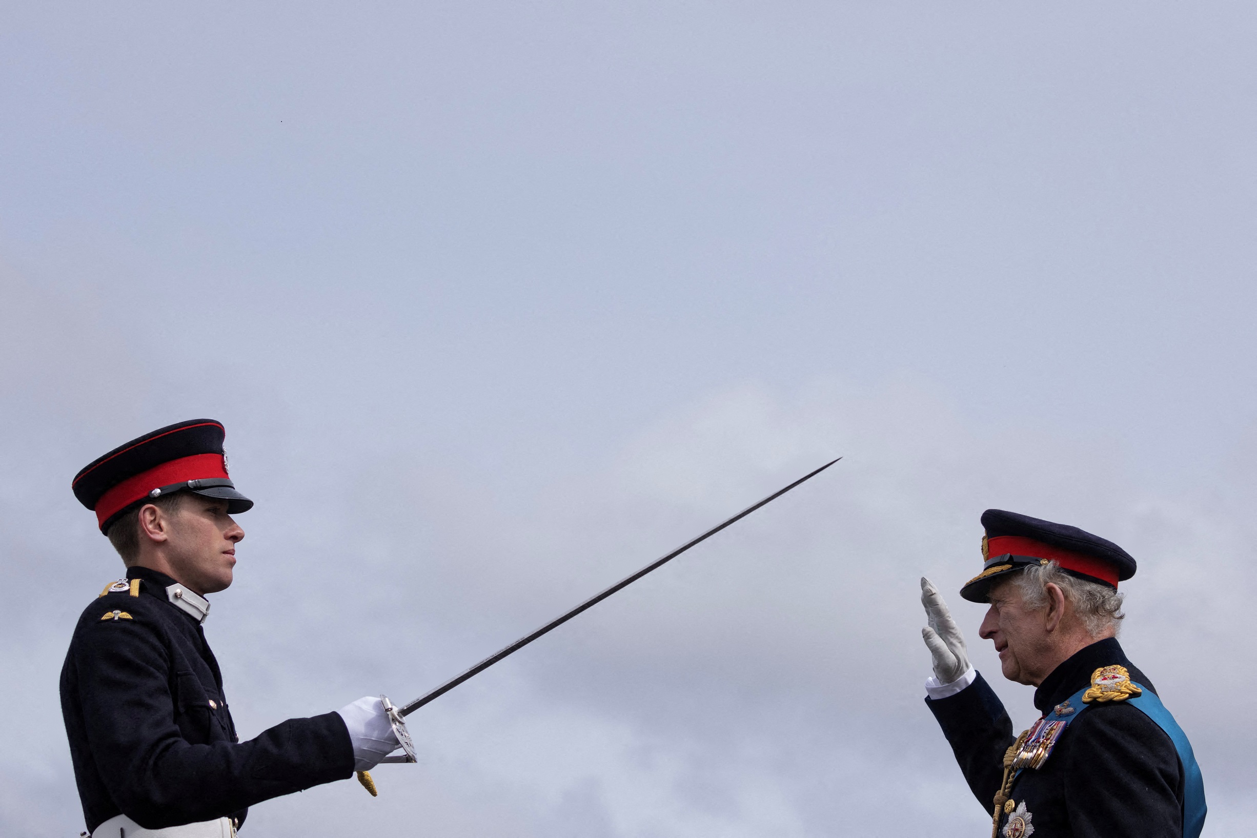 Britain's King Charles III presents an award for Senior Under Officer M G Jenkins, who was...