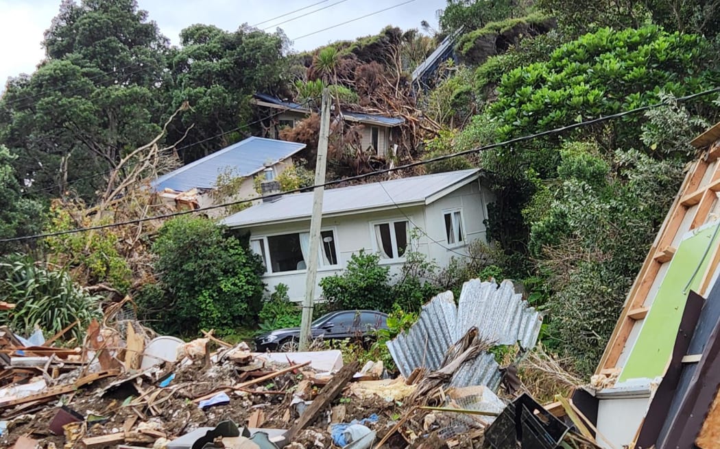 Slips and damaged houses in Karekare, West Auckland, in the wake of Cyclone Gabrielle Photo: RNZ ...