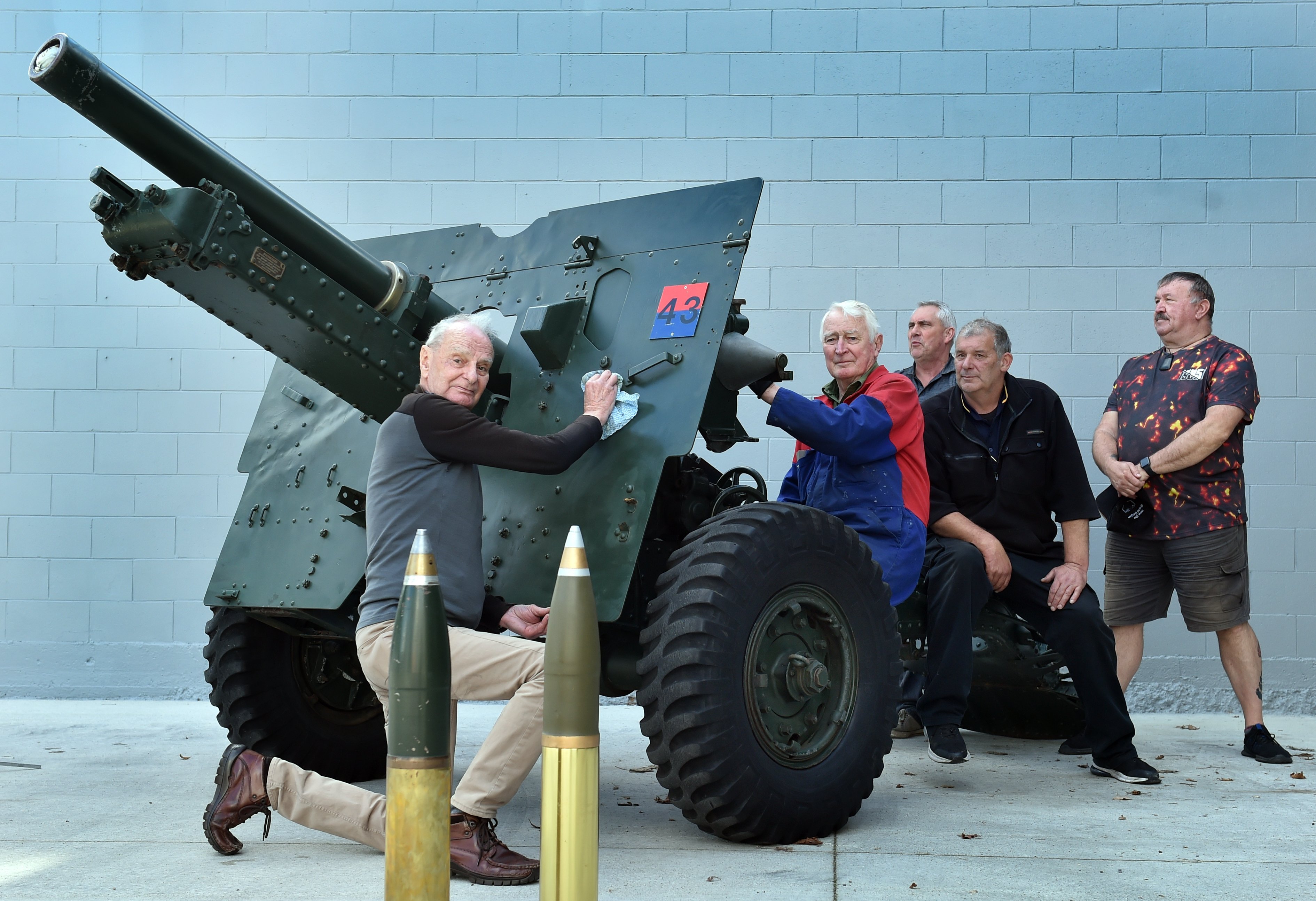Cleaning their 25-pounder field gun before Anzac Day are (from left) Alan Riddle, Bob Woodford,...