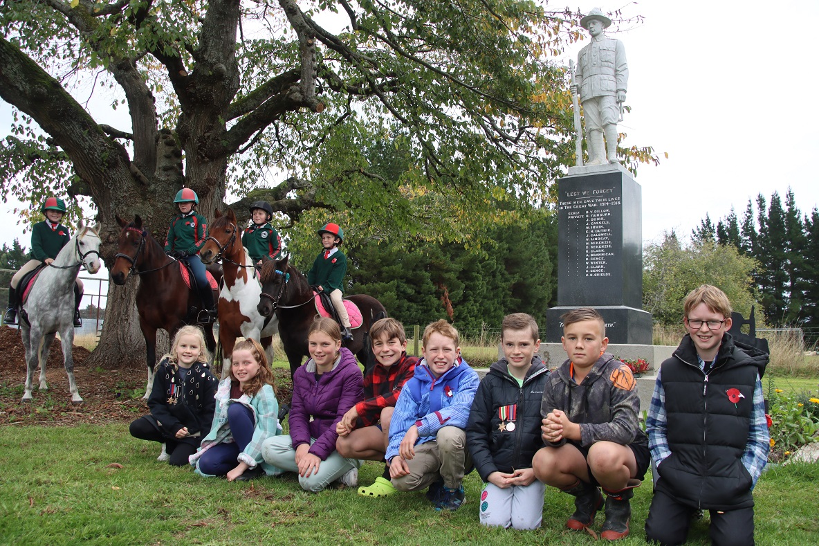 Wyndham Pony Club members and children from Menzies Ferry gather around the district’s war...