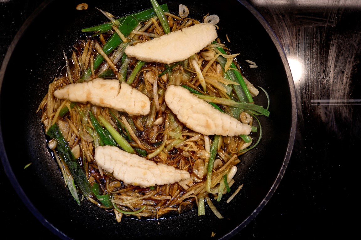 A dish containing pieces of 3D-printed cultivated grouper is prepared for a tasting at the...