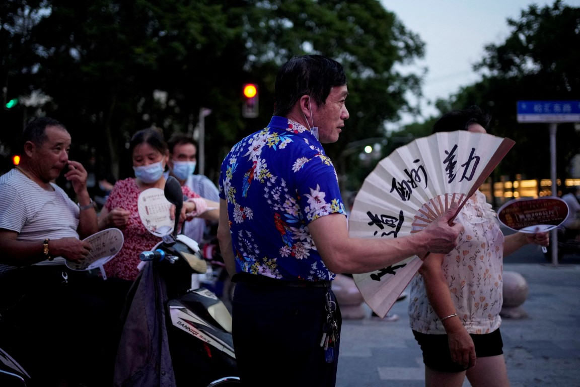 People use fans as they gather in a park amid a heatwave in Shanghai. File photo: Reuters People use fans as they gather in a park amid a heatwave in Shanghai. File photo: Reuters