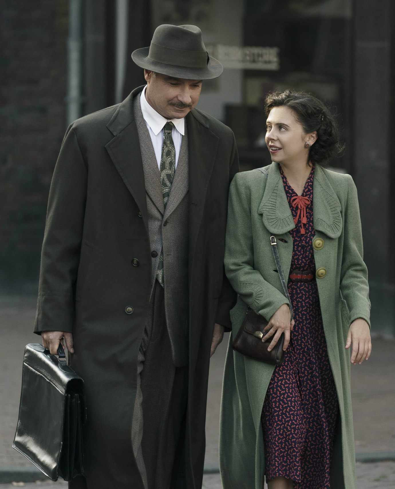 Otto Frank, played by Liev Schreiber, walks with Miep Gies, played by Bel Powley, in the...