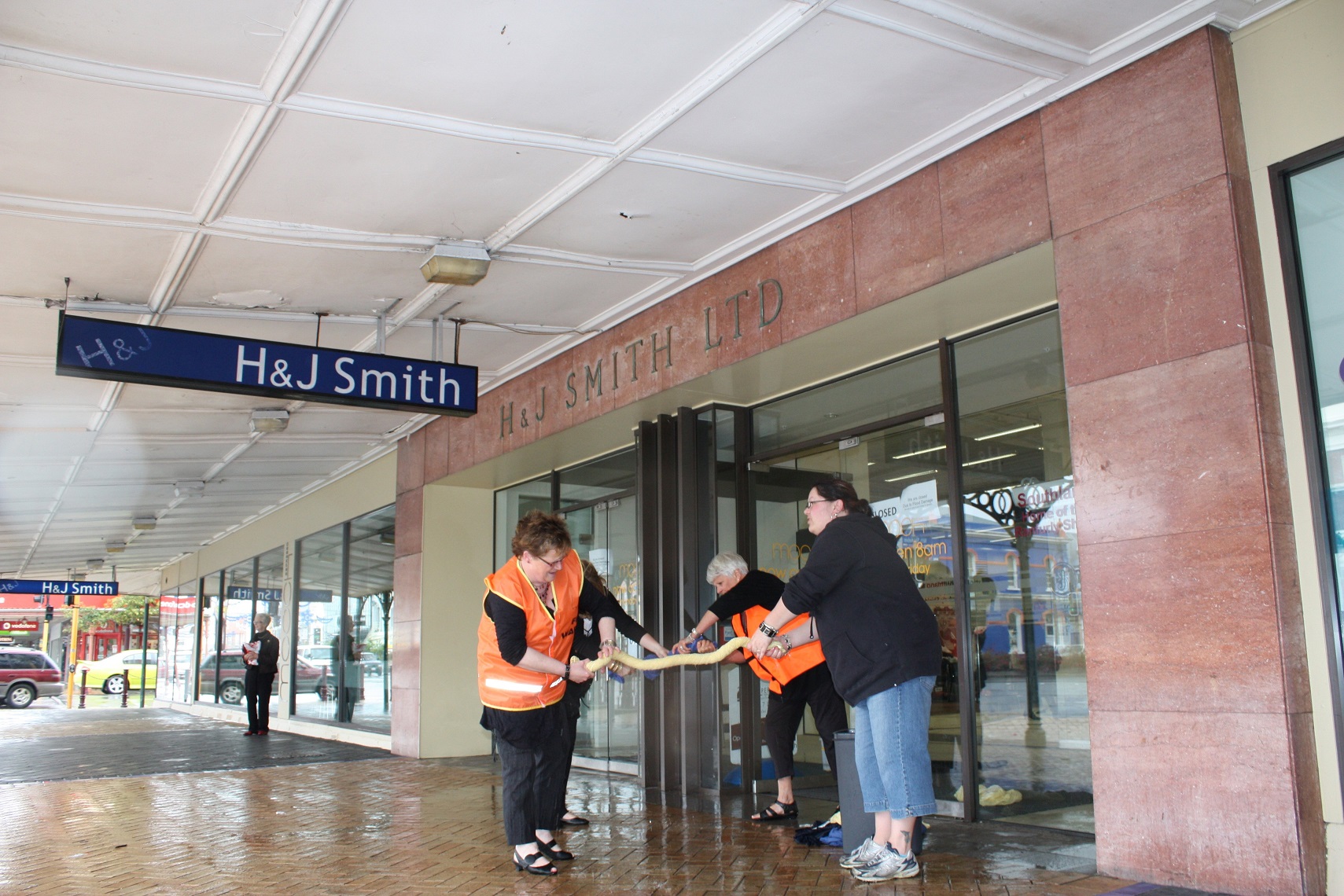 Staff work together to clear water from the store after a hailstorm in 2010. Photo: Selwyn Guyton