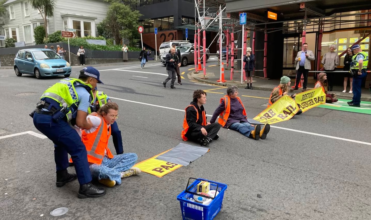 Police prepare to remove a protester blocking The Terrace in Wellington on Monday morning. Photo:...