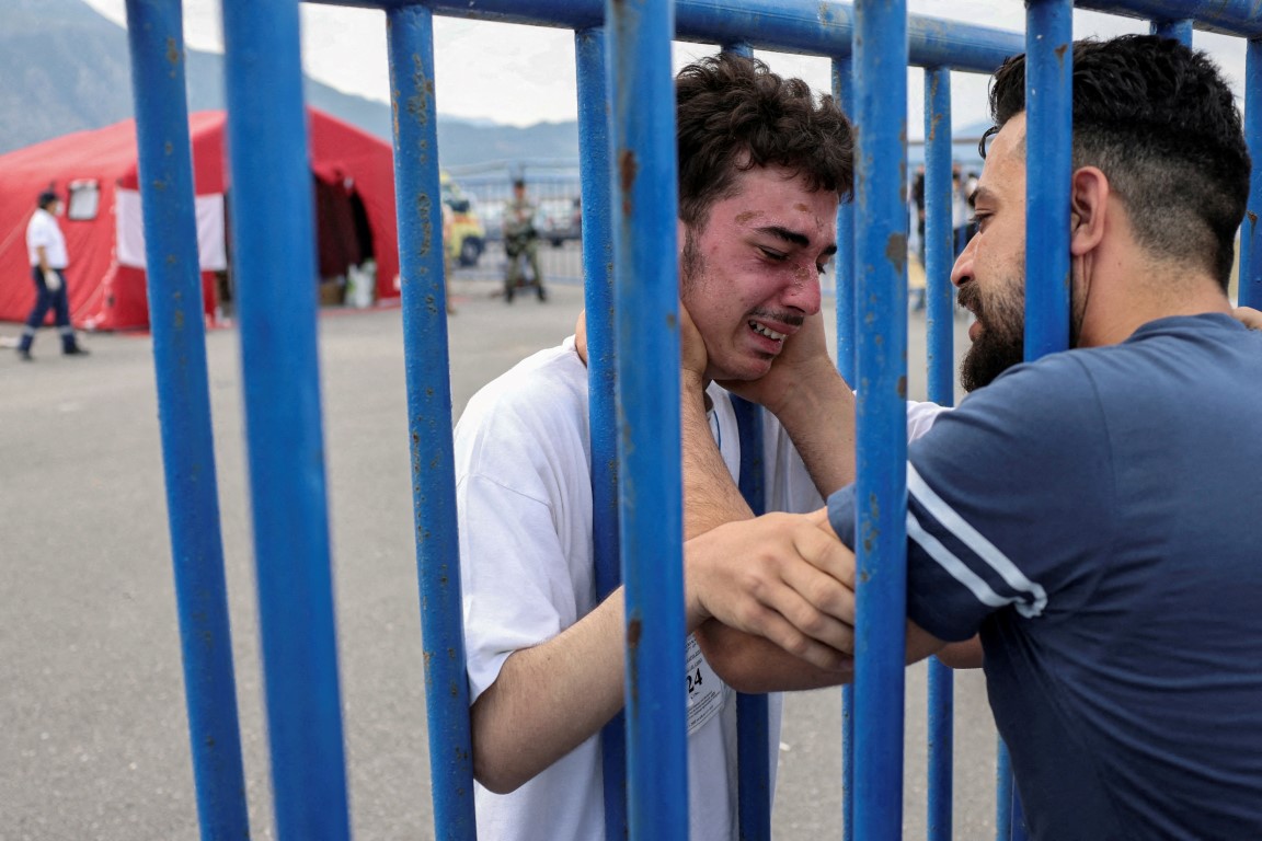 Syrian survivor Mohammad, who was rescued with other migrants after their boat capsized, cries as...