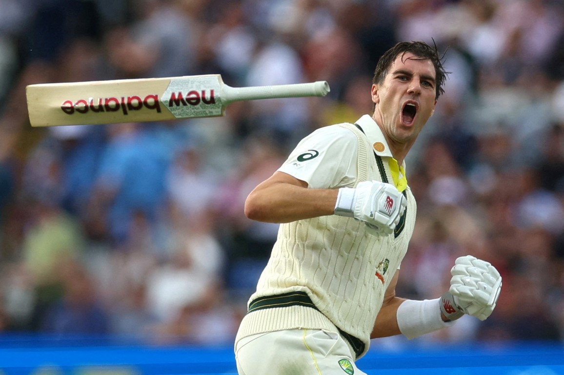 Australia's Pat Cummins celebrates after hitting the winning runs against England in the first...