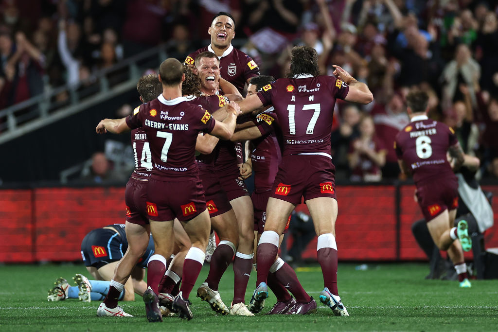 Queensland players celebrate a try to Cameron Munster against New South Wales. Photo: Getty Images