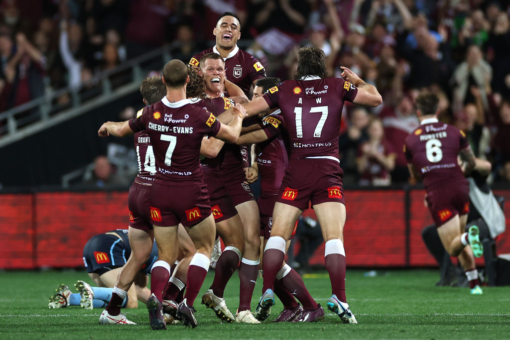 Queensland players celebrate a try to Cameron Munster against New South Wales. Photo: Getty Images Queensland players celebrate a try to Cameron Munster against New South Wales. Photo: Getty Images