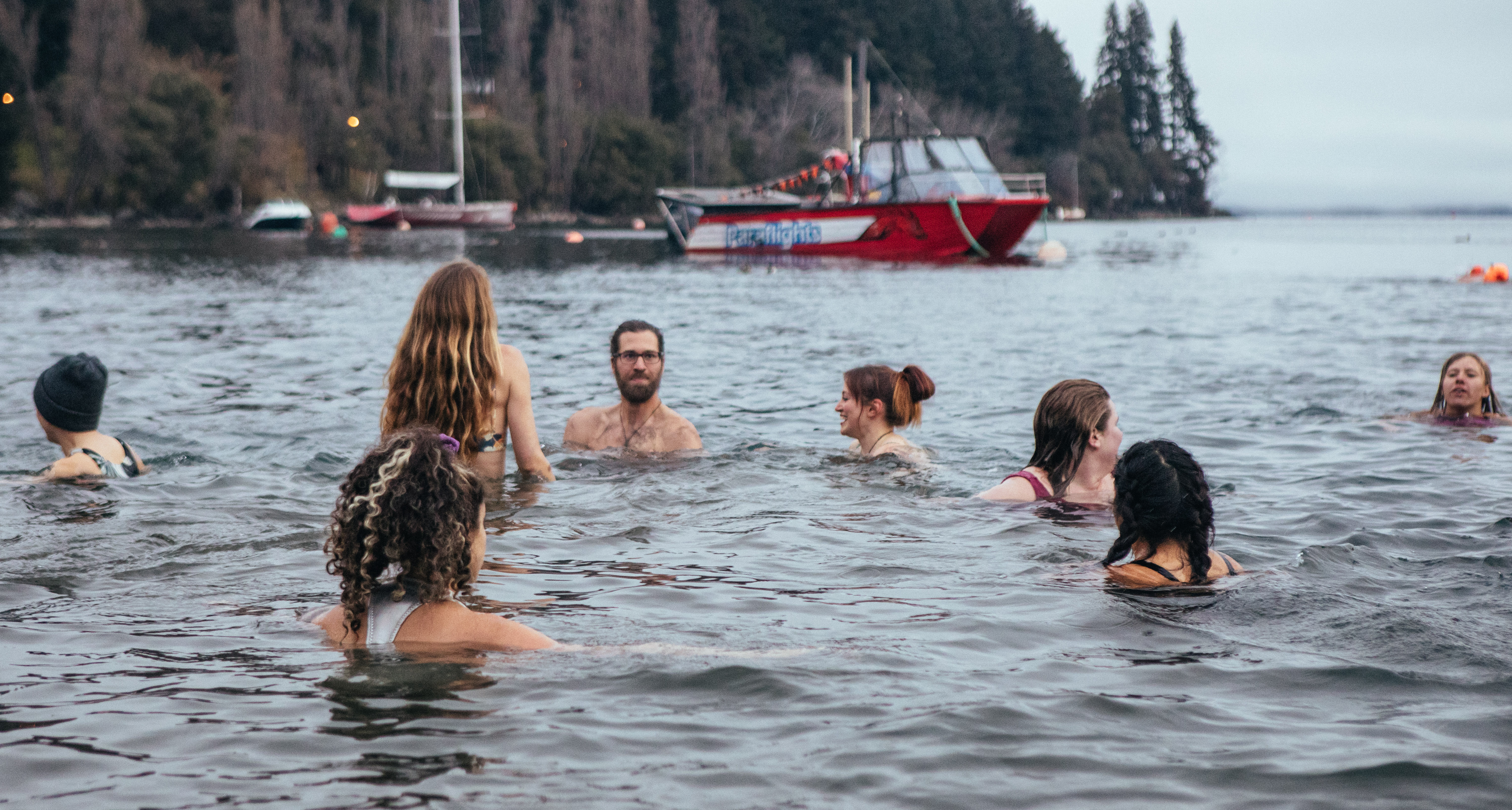 A group of hardy souls enjoy the cool waters of Lake Whakatipu on Thursday night, as part of...