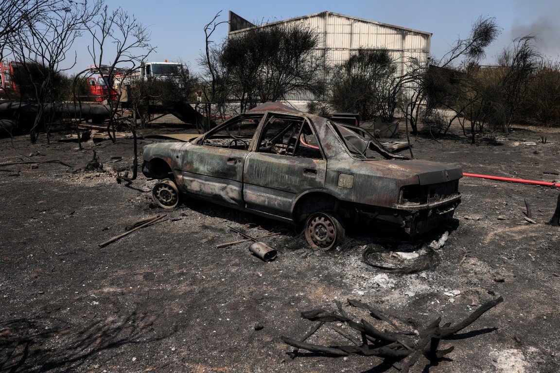 A destroyed car is seen at a recycling plant, following a wildfire in Sesklo, in central Greece....