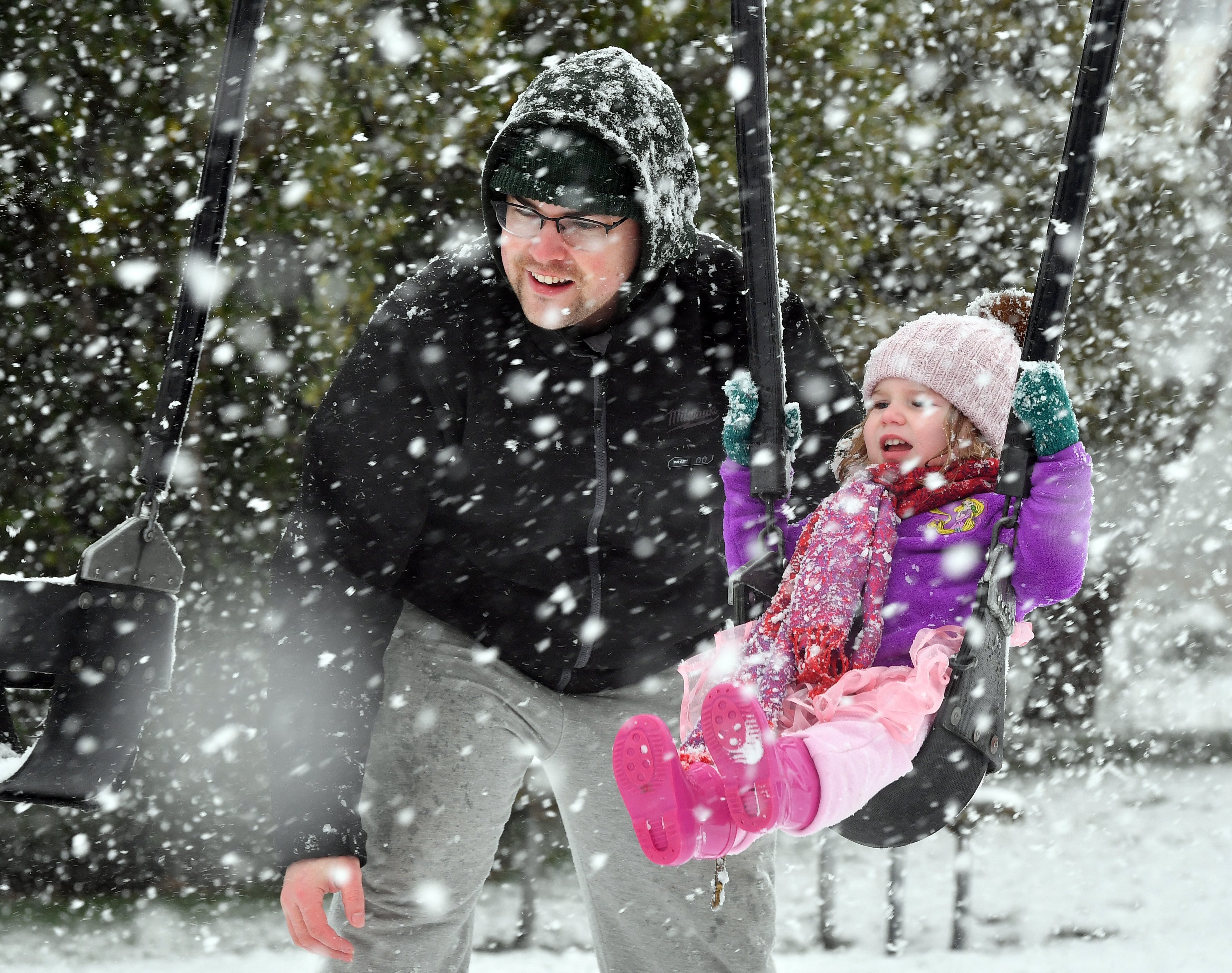 Cameron Fulton and his daughter Hazel (2) enjoy a swing in the Brockville playground as the snow...