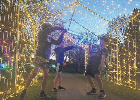 Three young boys enjoy sparring among the lights of Victoria Park at a previous festival. PHOTO:...