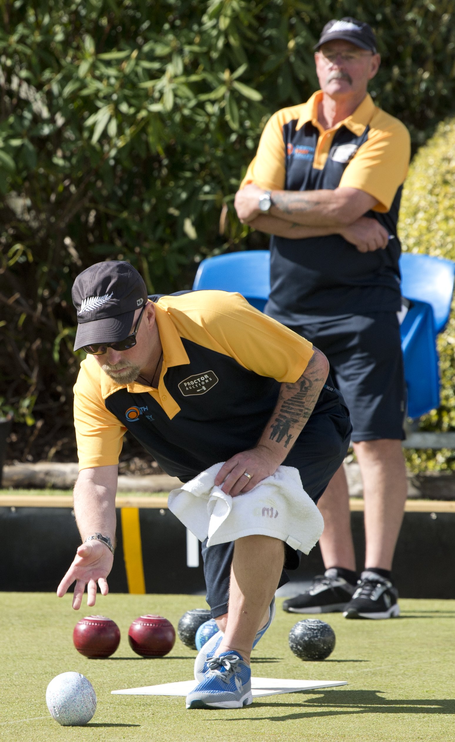 Kerrin Wheeler delivers his bowl as his father Colin watches during the North East Valley...