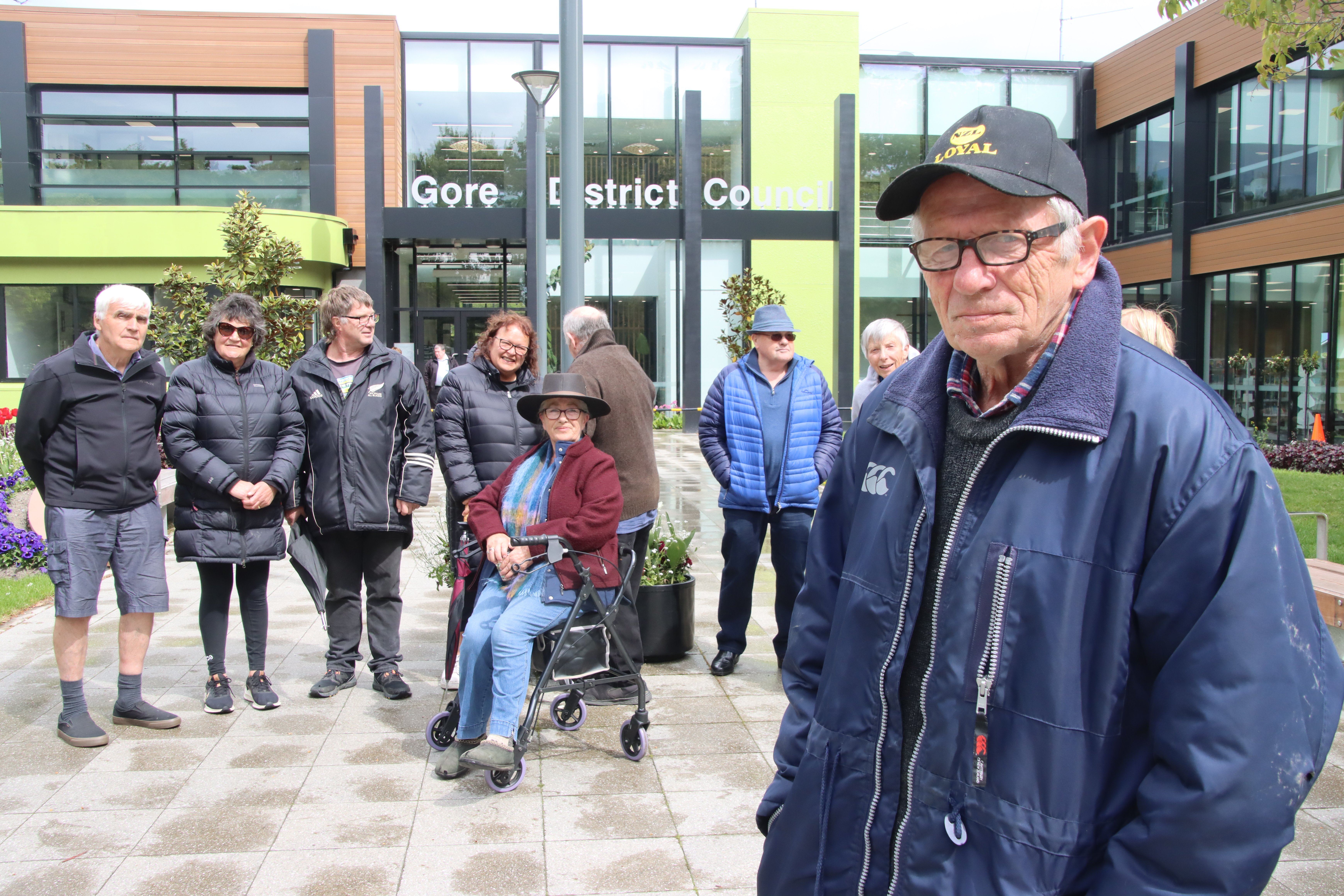 Gore District Citizen Action Group spokesman Jack McIntyre stands with the group of protesters...