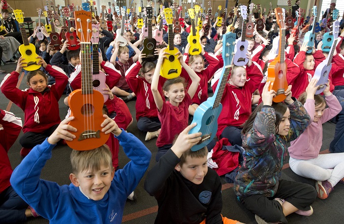 Primary school pupils from across Dunedin raise their ukuleles in salute as they begin the 12th...
