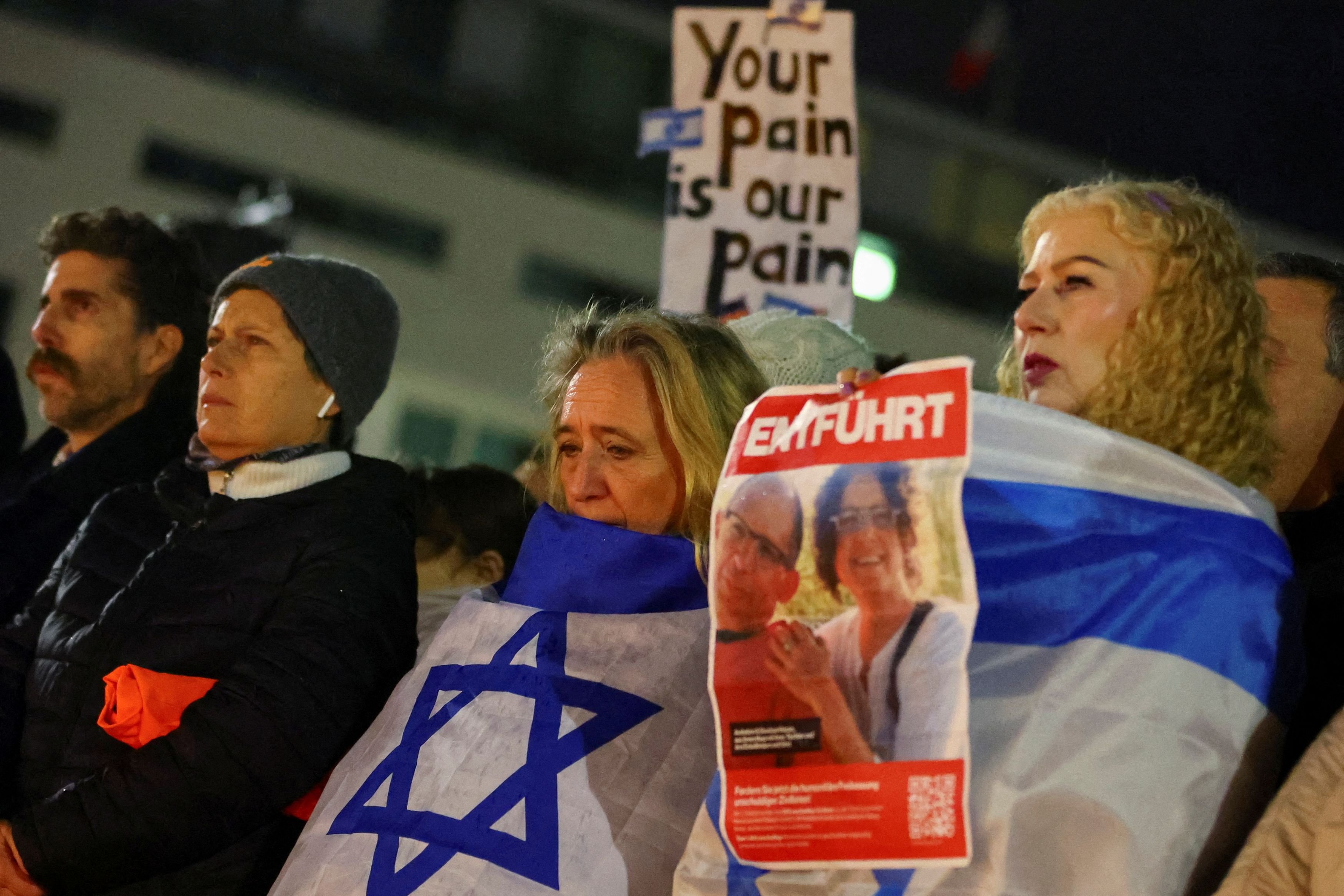 People commemorate the victims of October 7 Hamas' attack in front of Brandenburg gate, amid the...