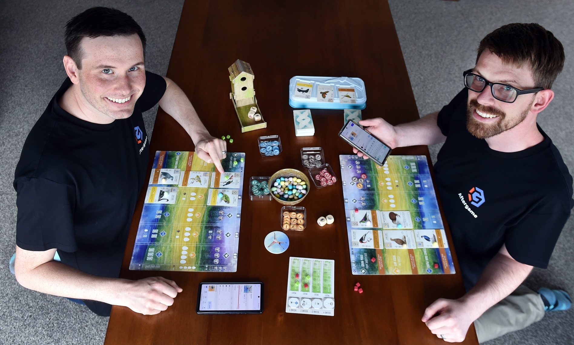 Playing Wingspan are Eric Poulin (left) and John Brent who have developed a board game tracking...