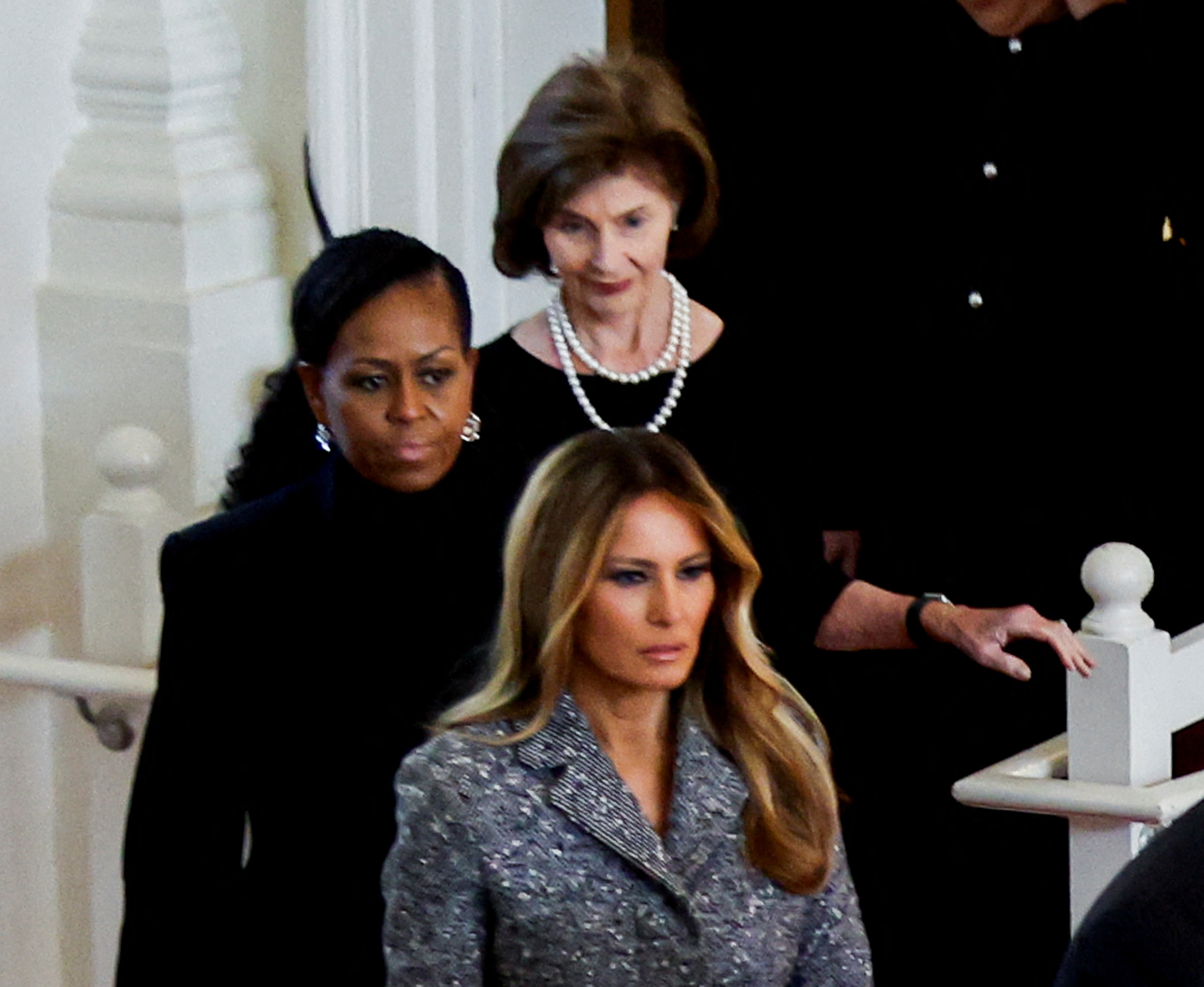 Former US first ladies Melania Trump (front) Michelle Obama and Laura Bush attend the tribute...