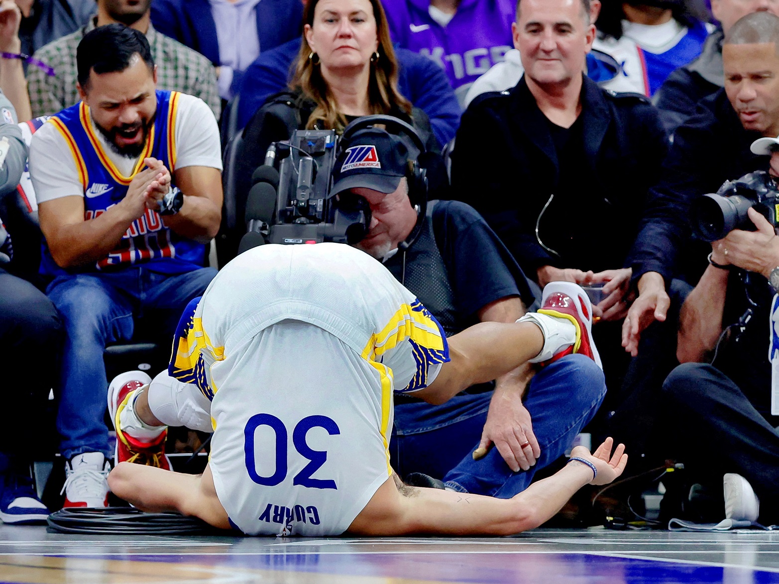 Golden State Warriors guard Stephen Curry is flipped upside down after a play during the second...