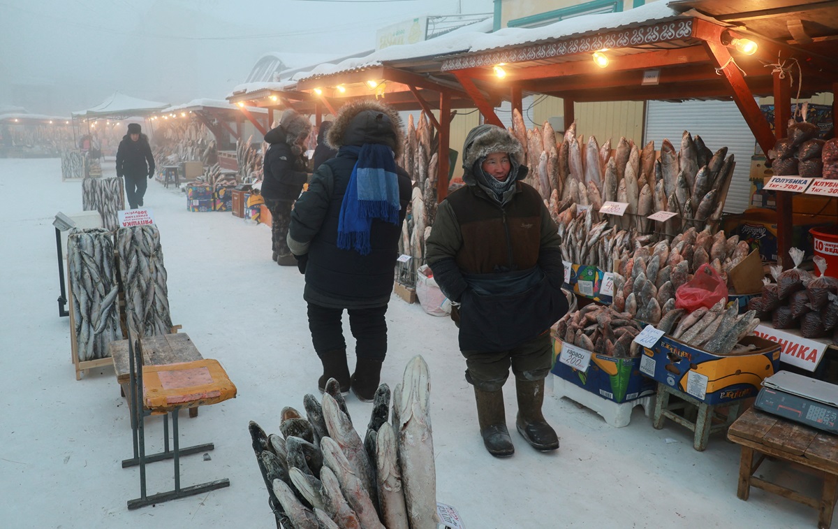 A vendor stands next to deep-frozen fish at an open-air market in Yakutsk, Russia. Photo: Reuters