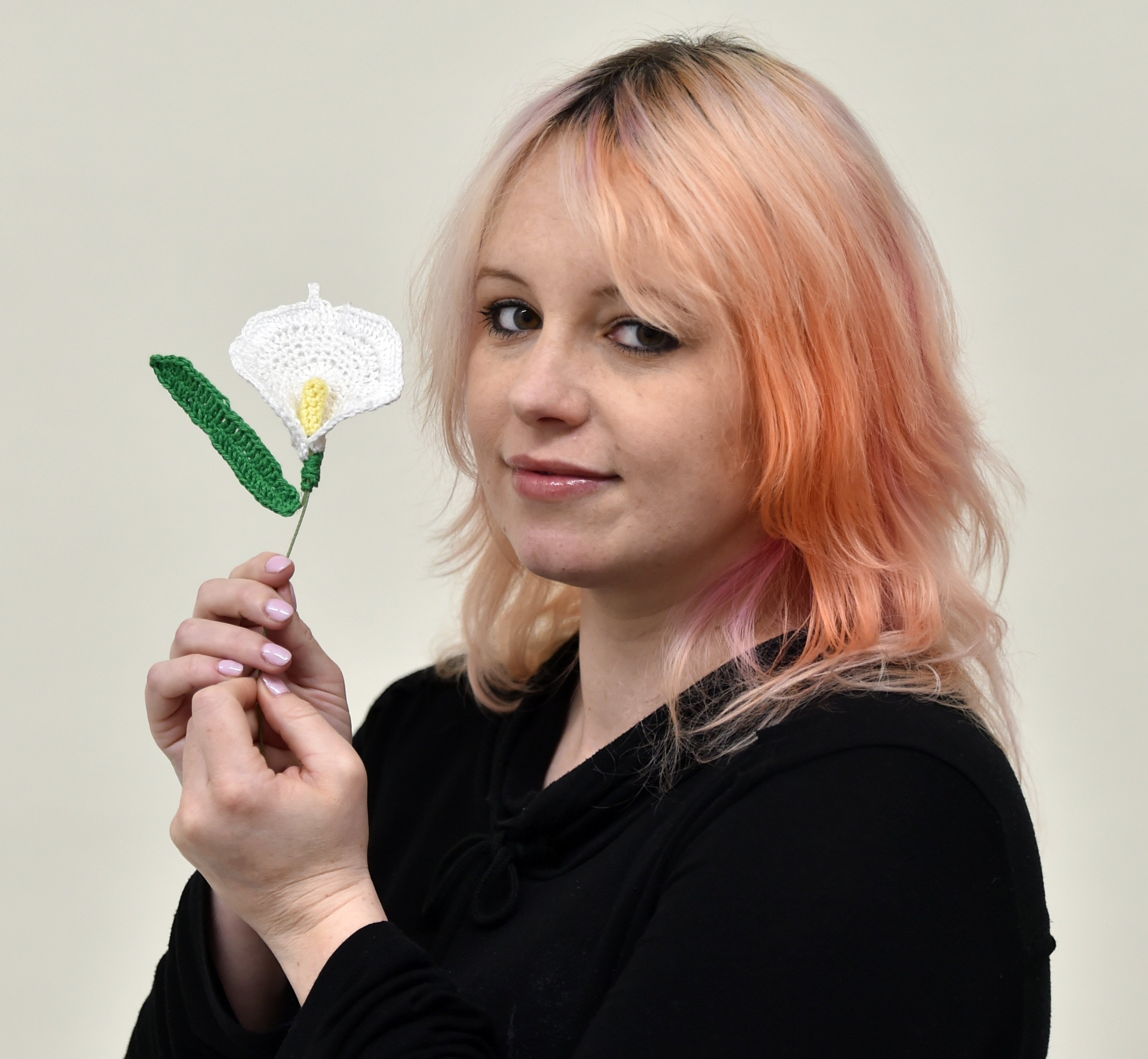 Bryony Kentfield with her crocheted lily. Photo: Gregor Richardson