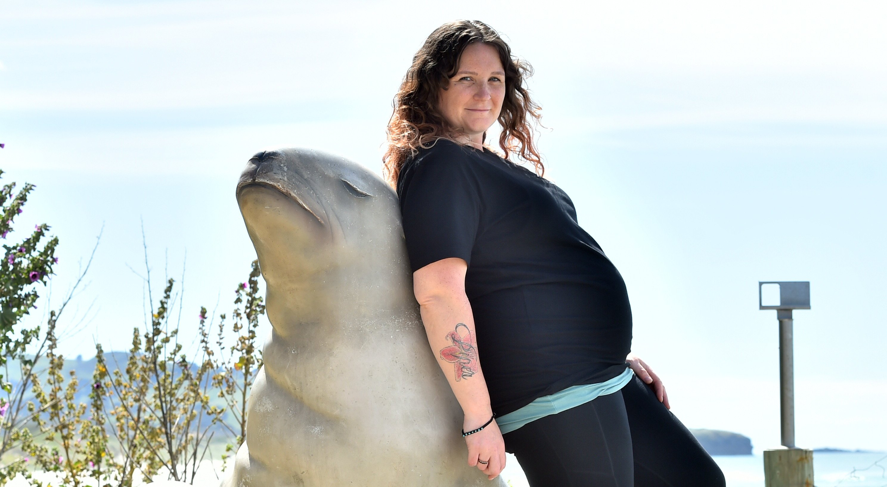 Expectant mum Chelsea McGaw leans on another mum at St Clair Esplanade yesterday morning. Photo:...