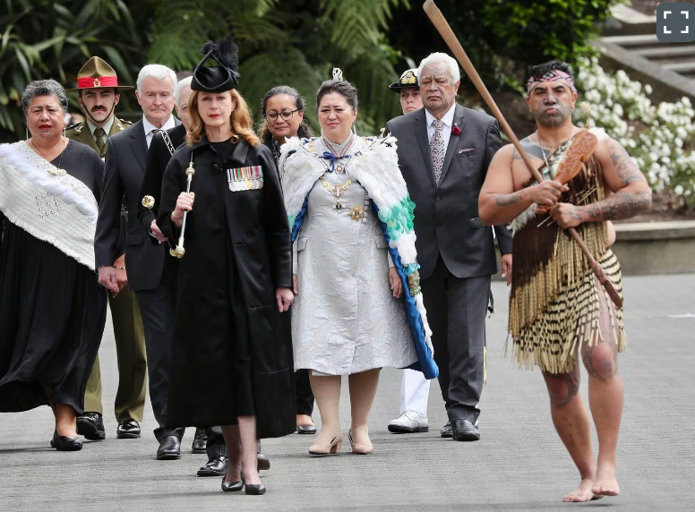 The Usher of the Black Rod, Sandra McKie (front), leads dignitaries including Governor-General...
