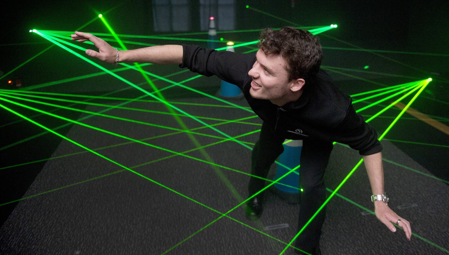 Otago Museum communicator Nathaniel Peacock showing off his stealthy moves at the Laser Maze in...