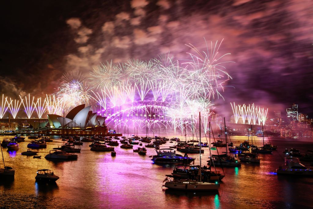 Fireworks light up the sky over the Sydney Harbour Bridge and the Sydney Opera House during New...