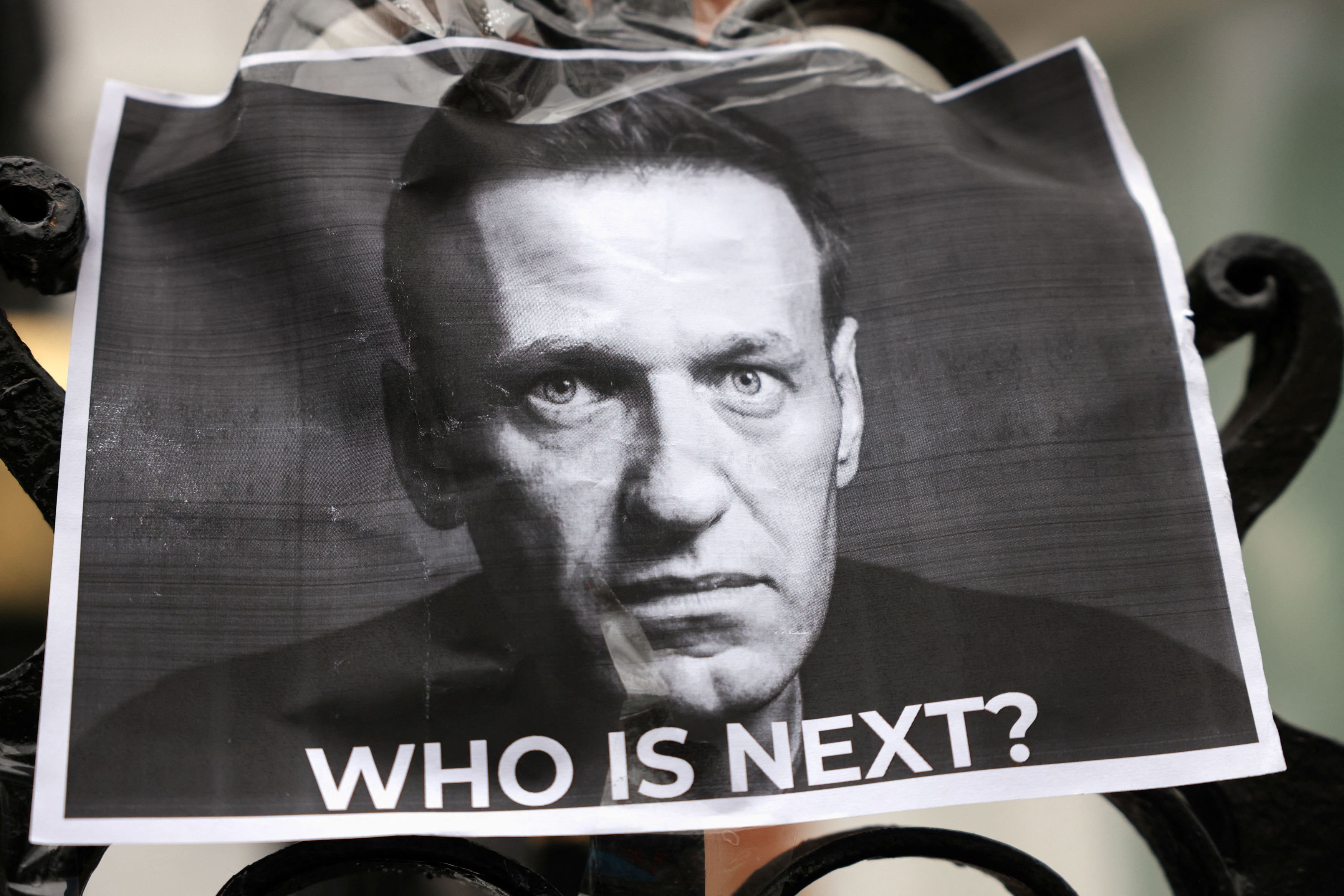 A picture of late Russian opposition leader, Alexei Navalny, is attached to a fence outside the...
